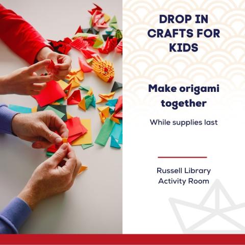 Hands folding origami paper of various colors